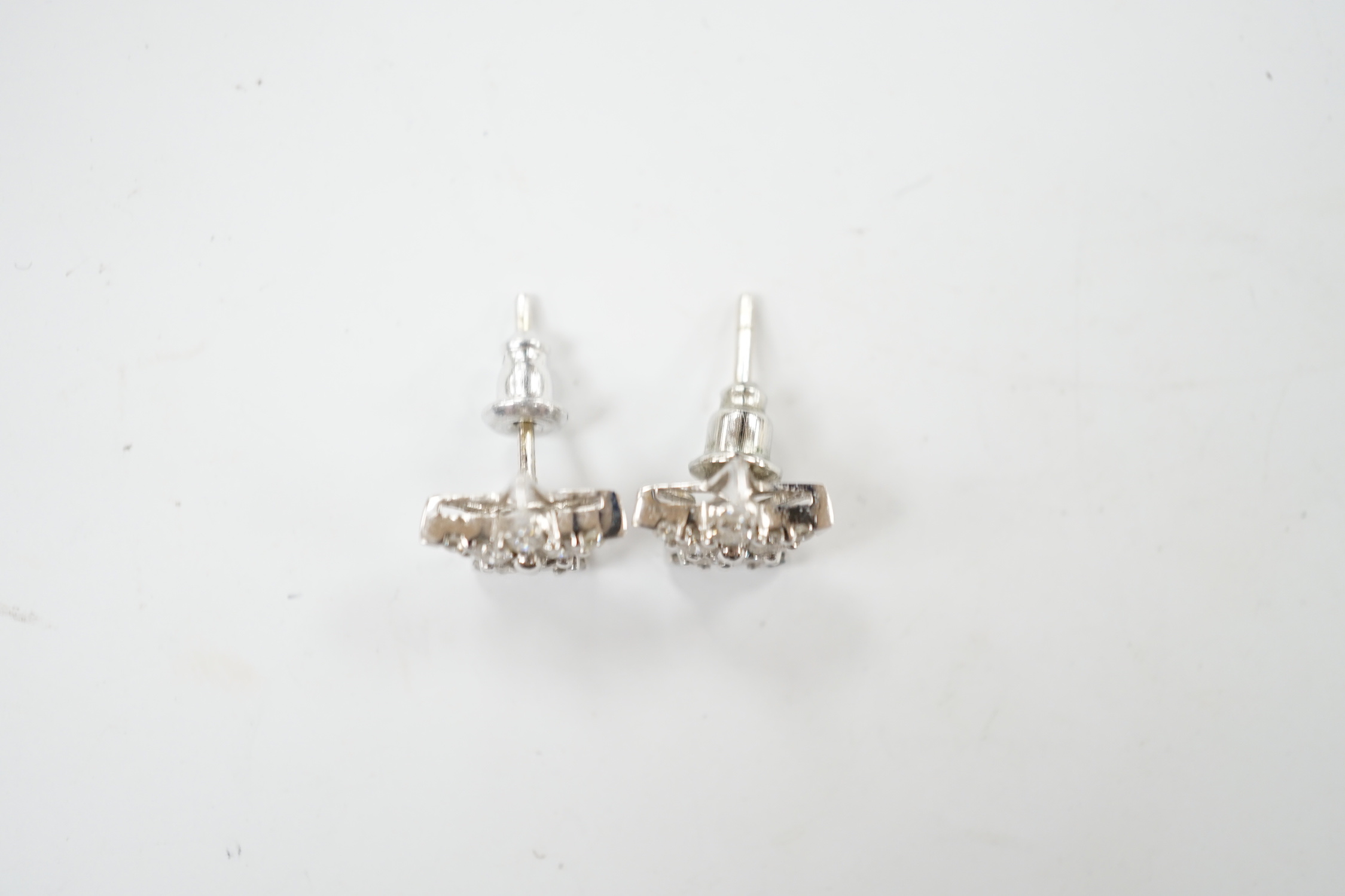 A modern pair of 18ct white gold and diamond chip star shaped ear studs, 10mm, gross weight 2.2 grams.